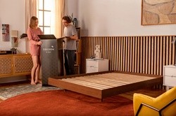 Couple opening a Cocoon mattress box in a styled bedroom