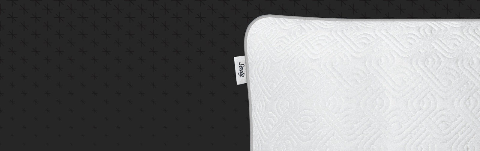 A detail shot of one Sealy Adjustable pillow corner, with the Sealy tag visible