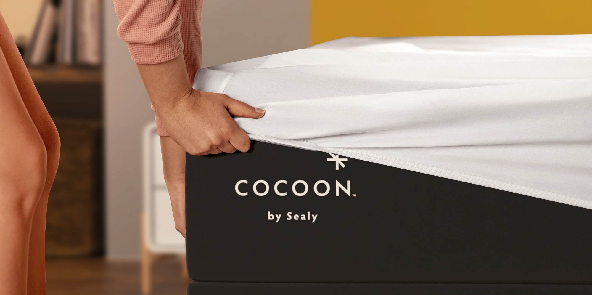 Woman placing sheet on Cocoon mattress